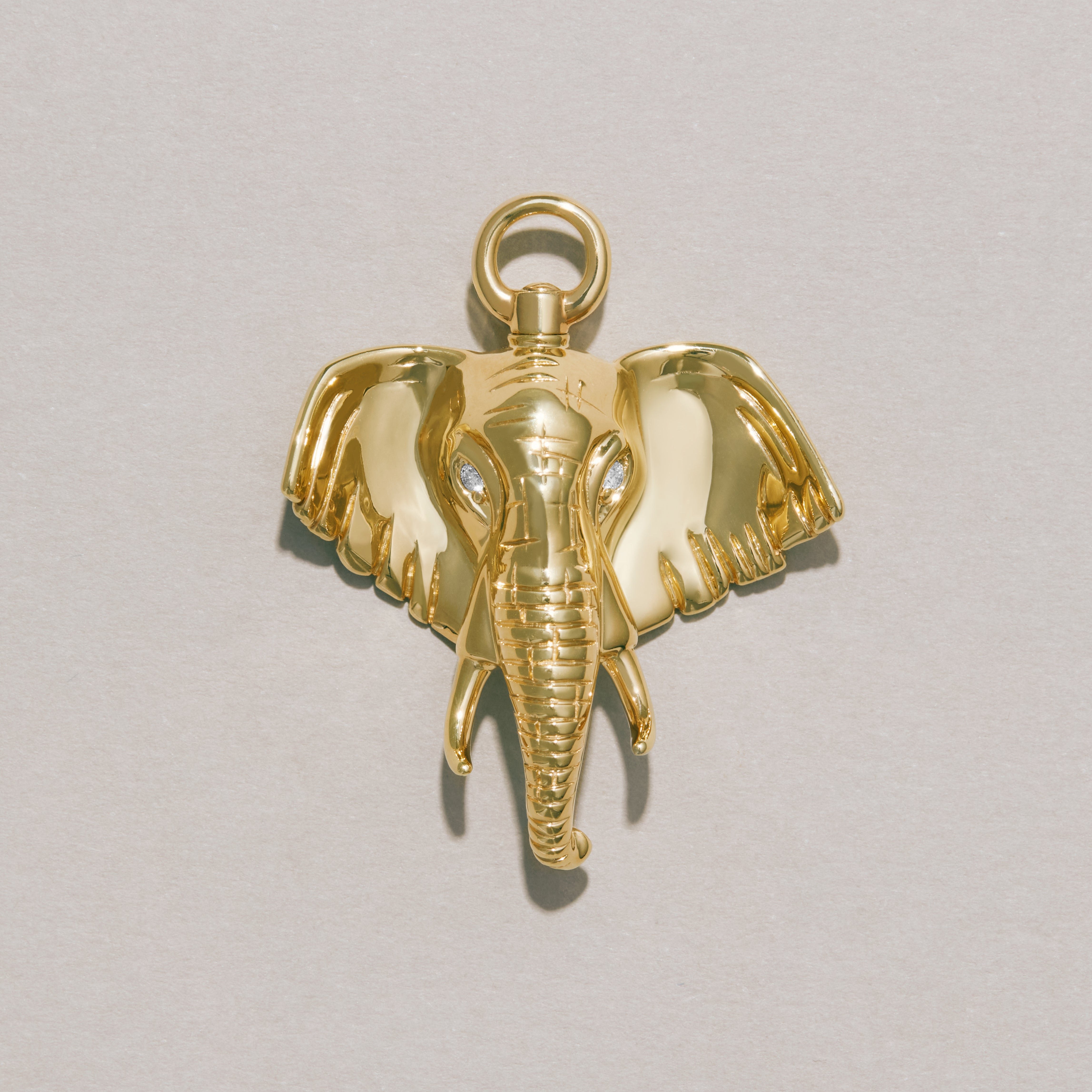 Close-up of polished gold elephant charm pendant