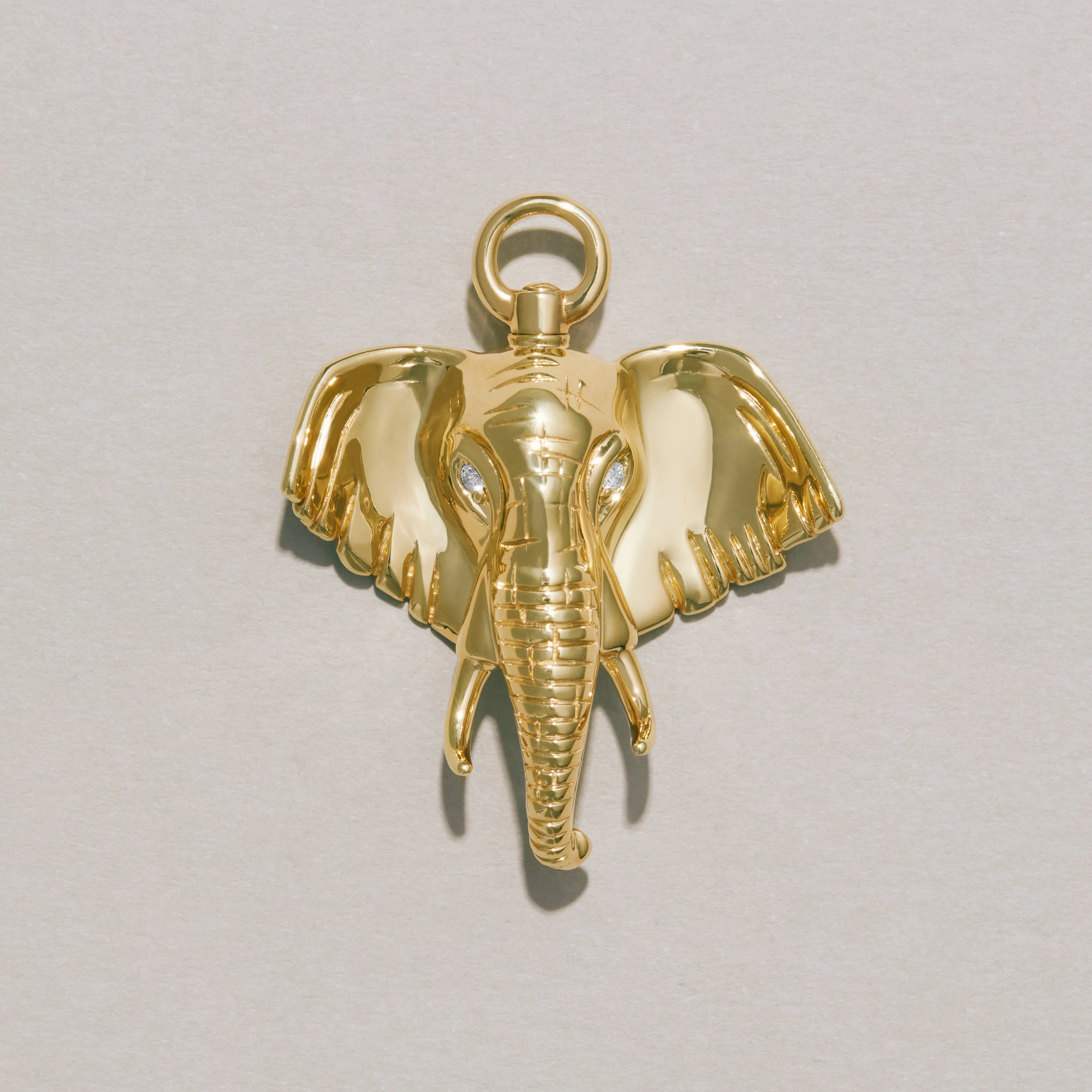 Close-up of polished gold elephant charm pendant