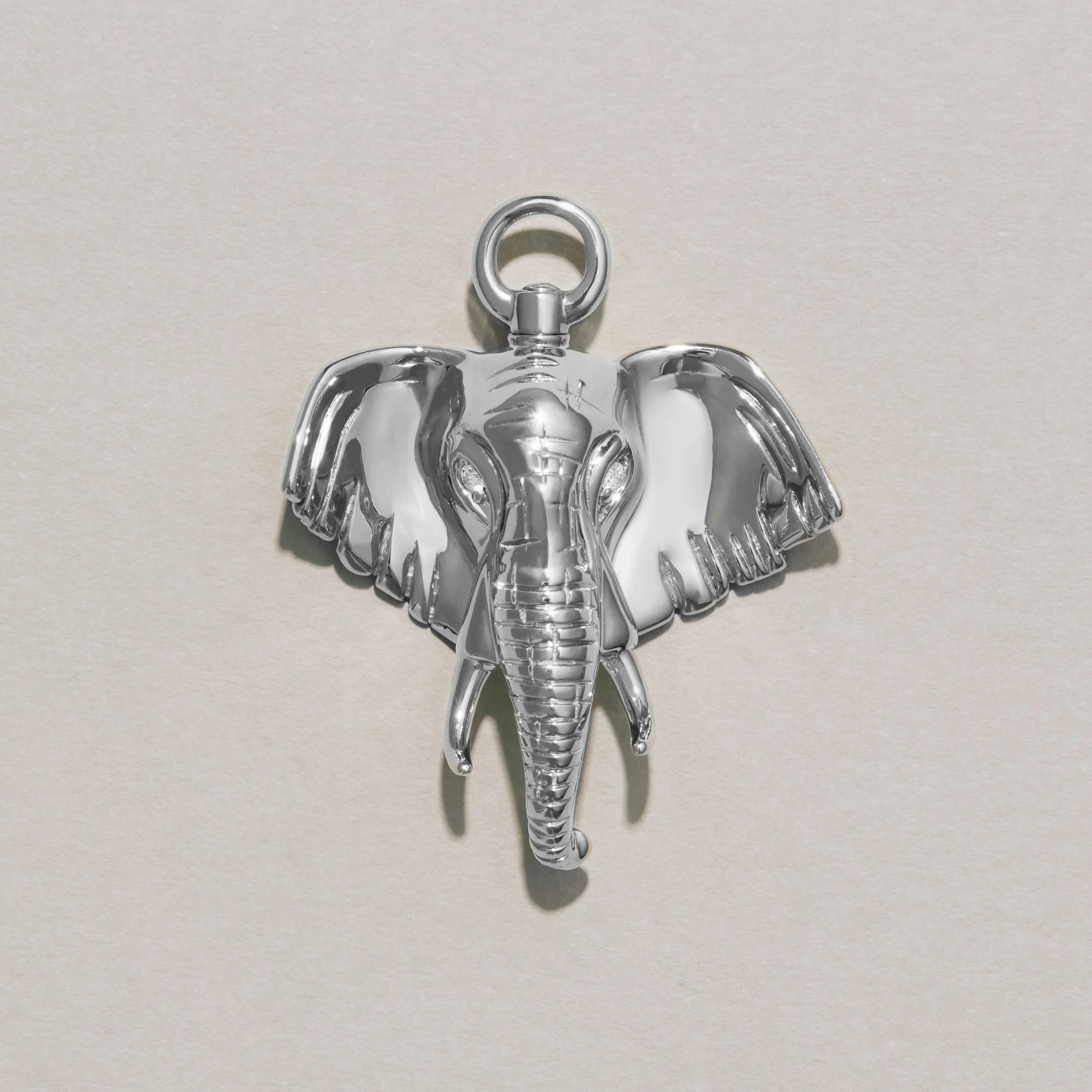 Close-up of polished silver elephant charm pendant