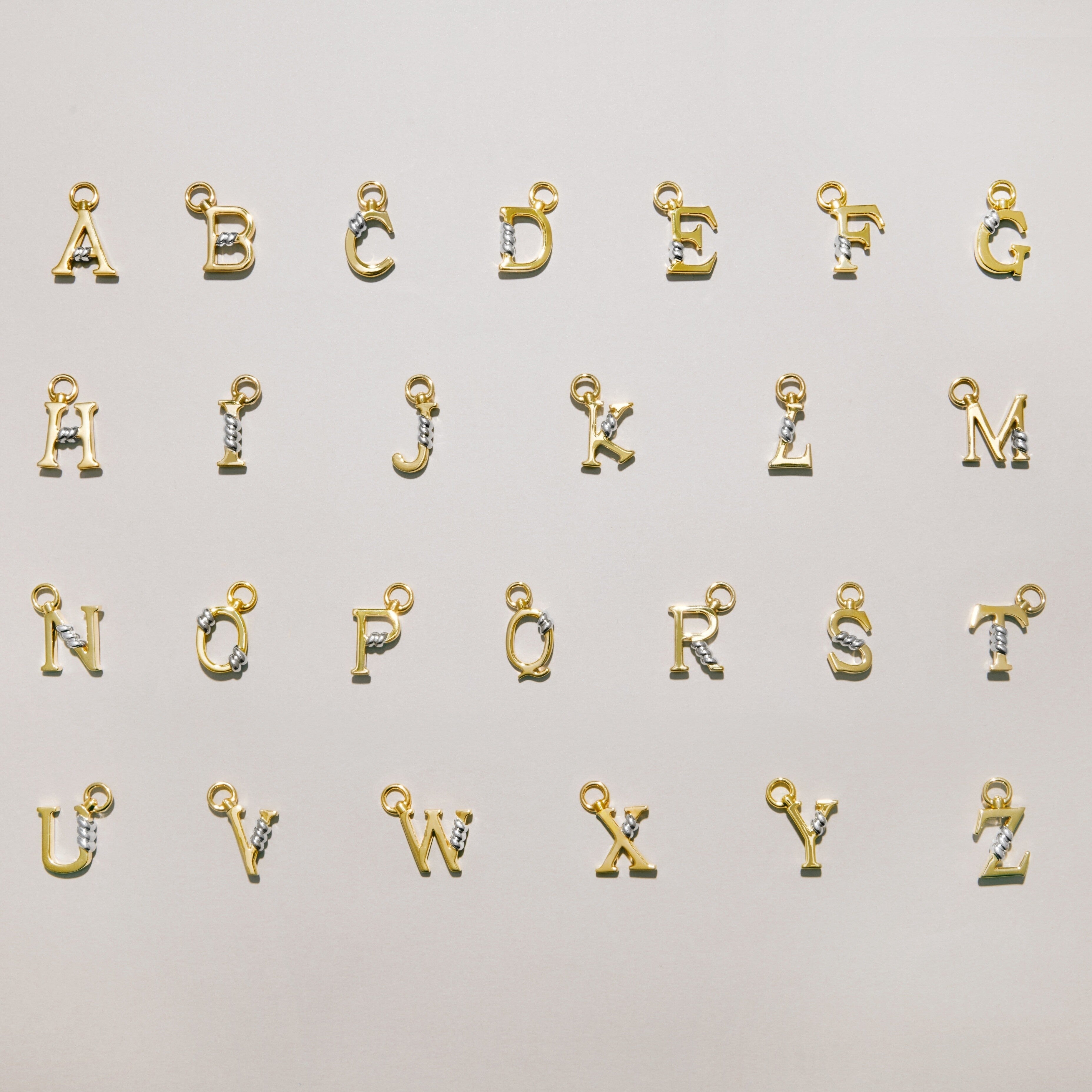 Full A to Z collection of gold letter charms each featuring a gold rope twist detail, arranged on a light background.