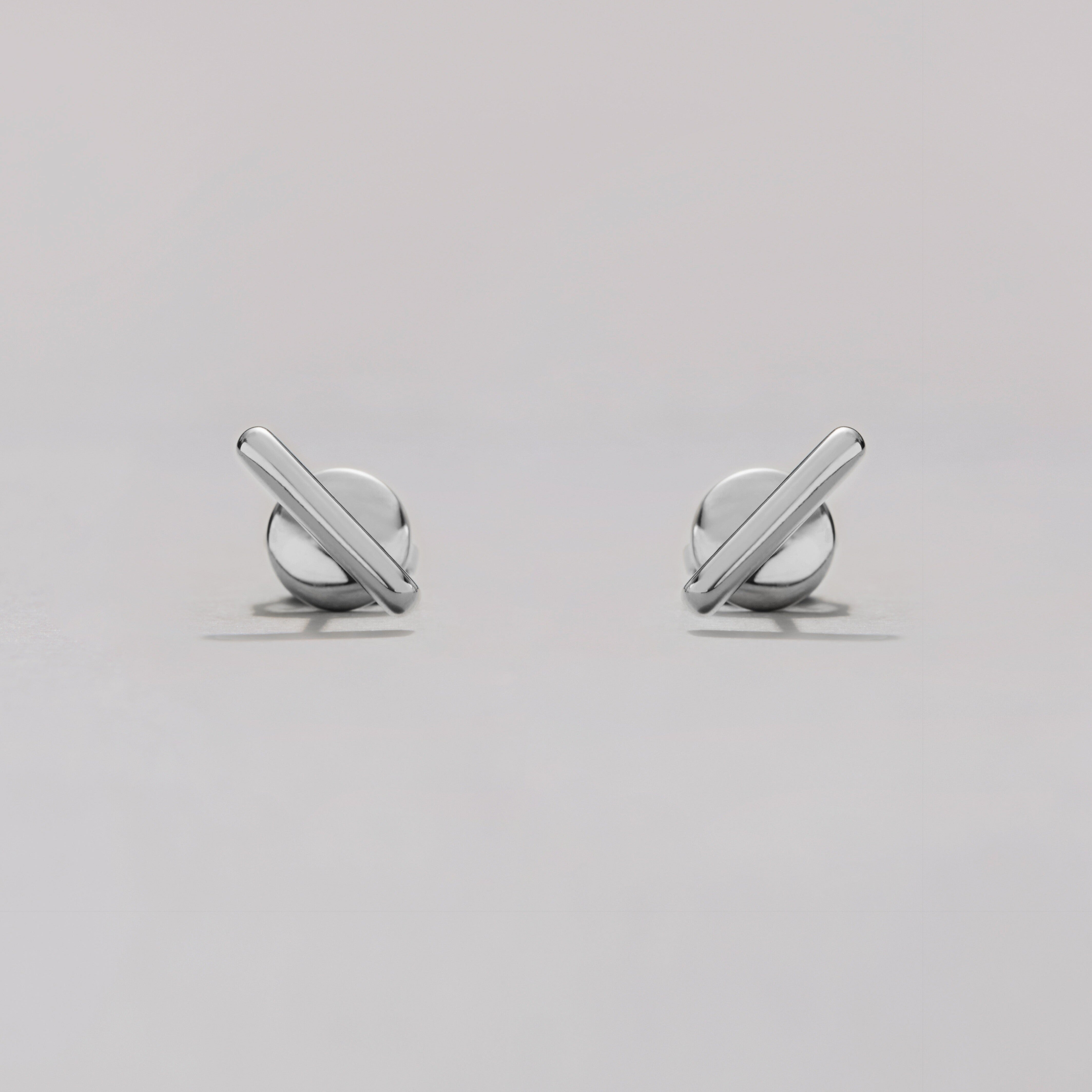 Pair of silver bar earrings on a light gray background