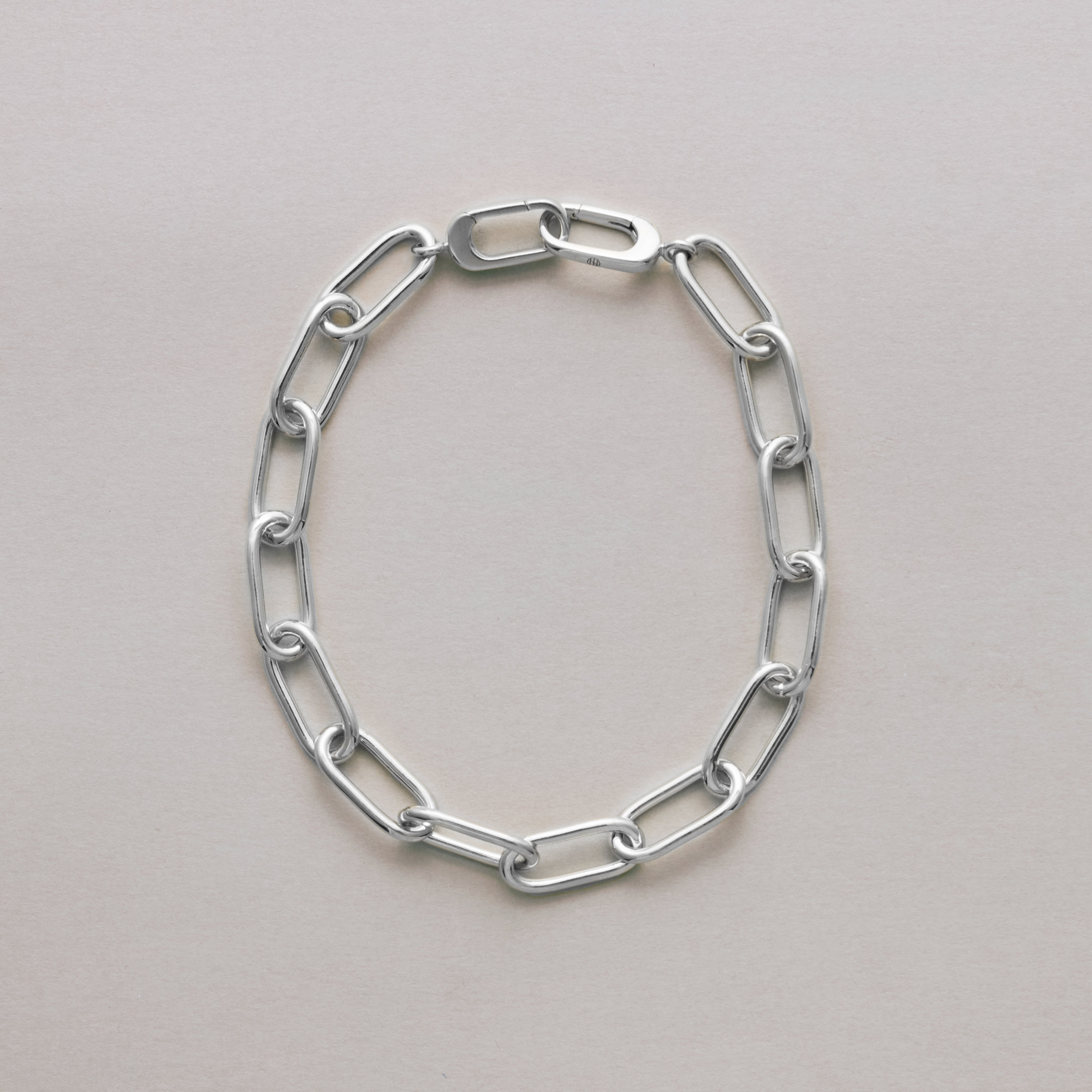 Sterling silver rectangular link chain bracelet displayed flat on neutral background.