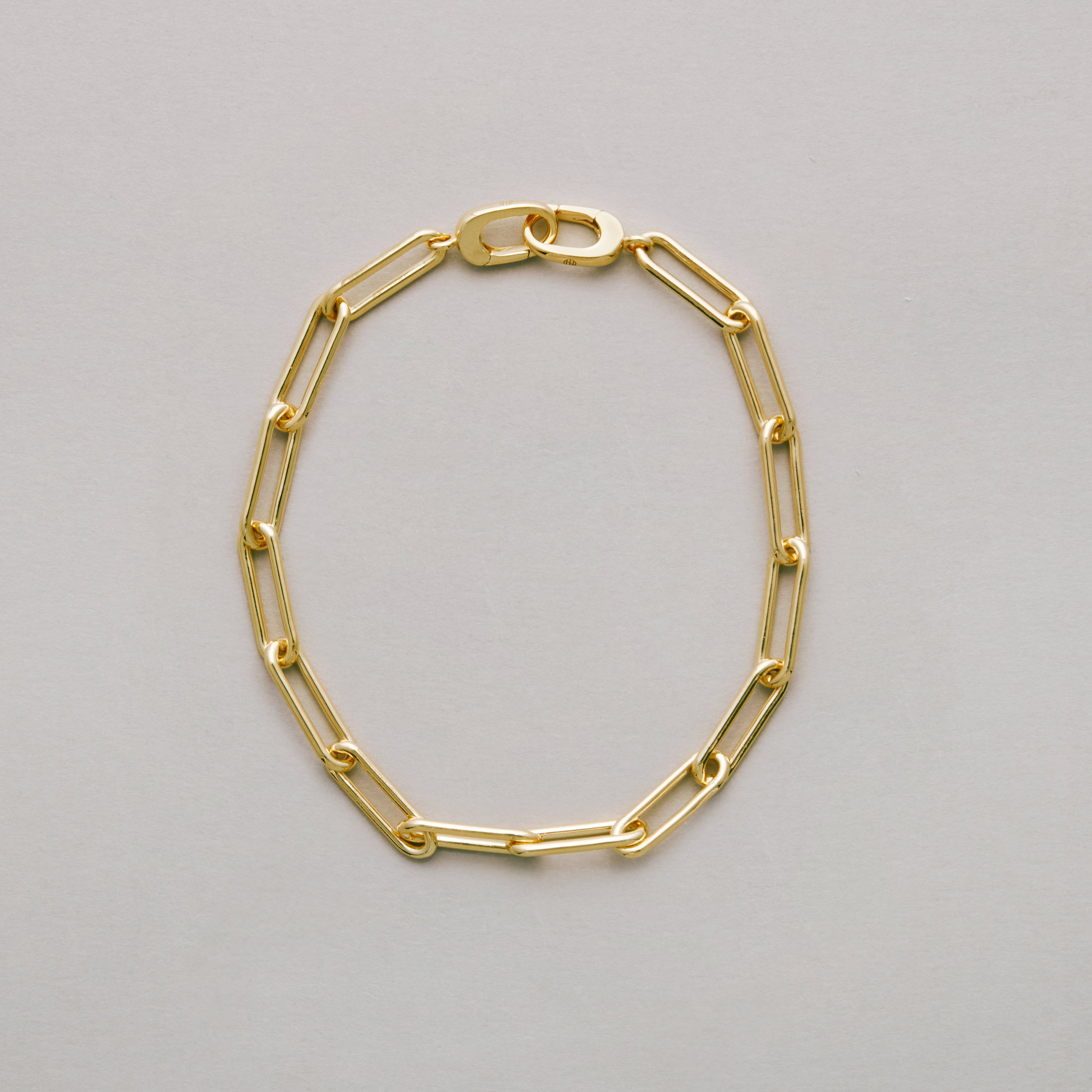 Sleek gold link bracelet in classic design on neutral background.