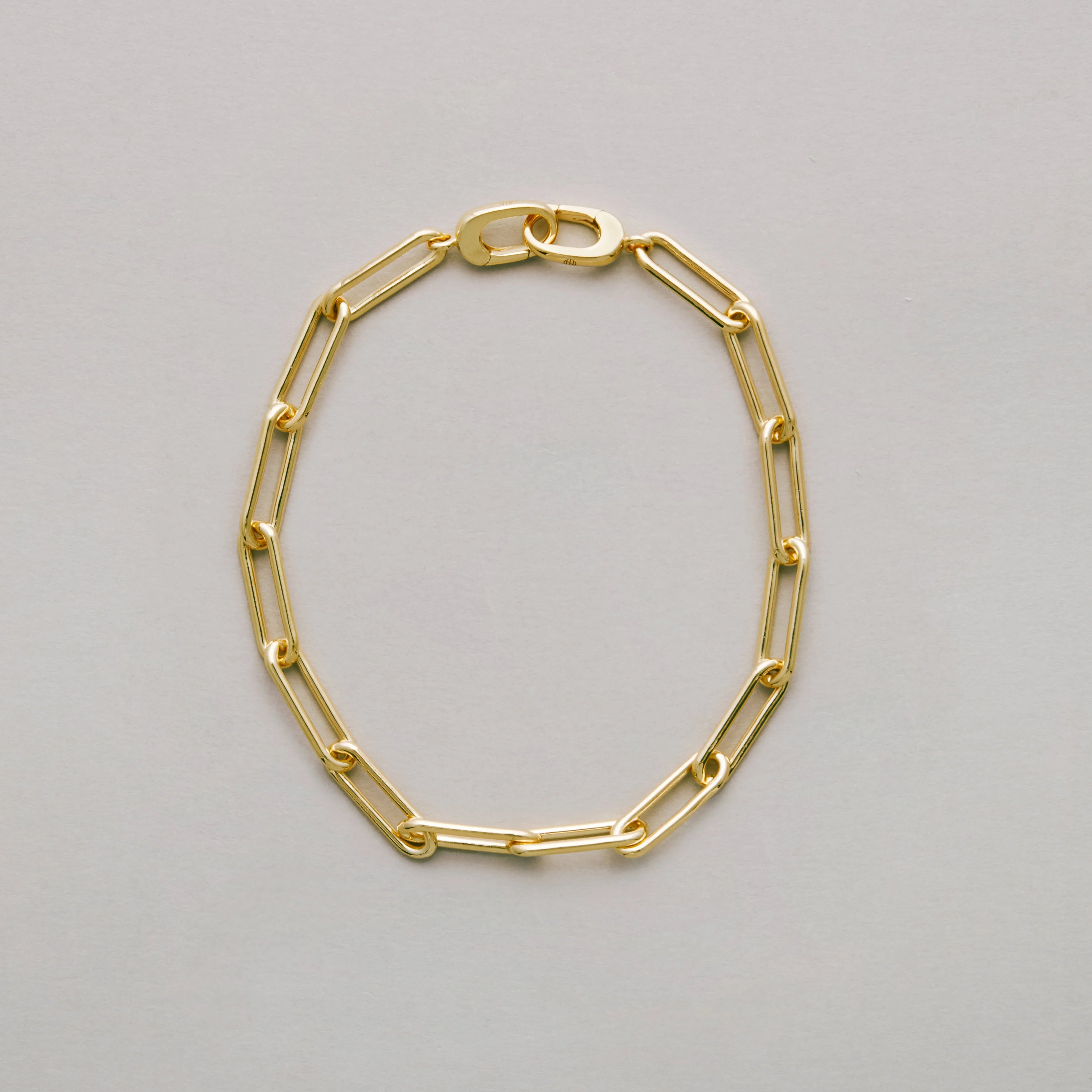 Sleek gold link bracelet in classic design on neutral background.