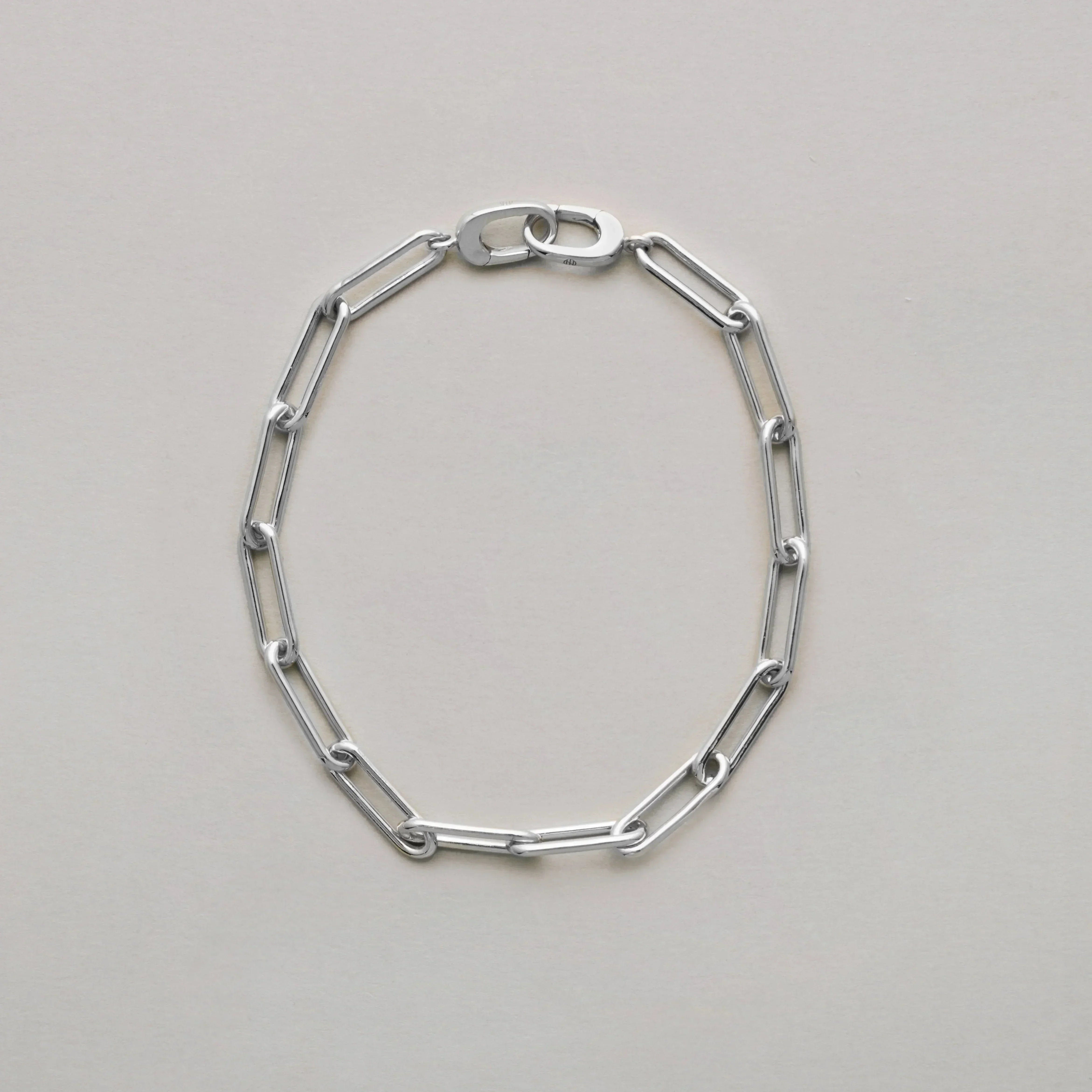 Sleek silver link bracelet in classic design on neutral background.