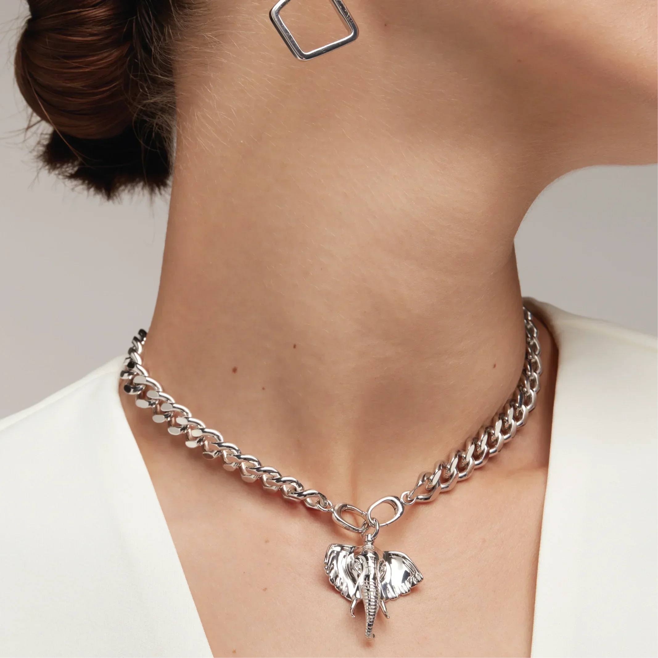 Silver Cuban chain choker with elephant charm charm on model