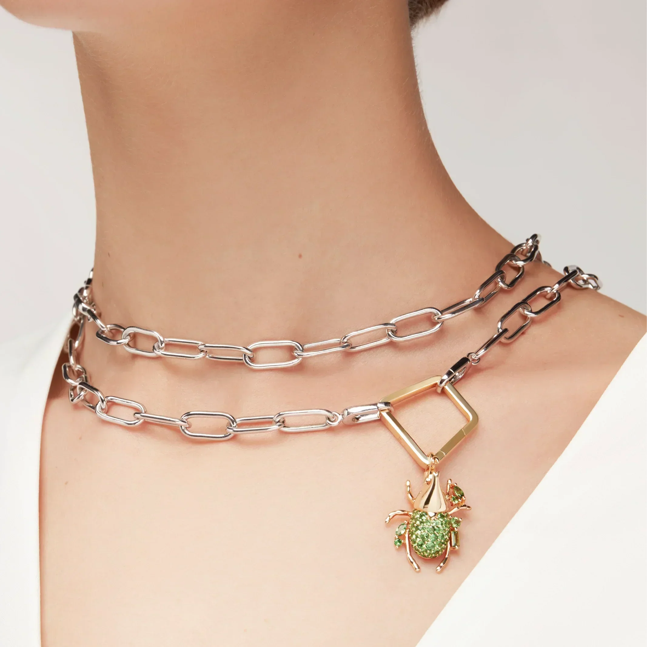 Silver paperclip chain necklace wrapped as choker with green beetle charm