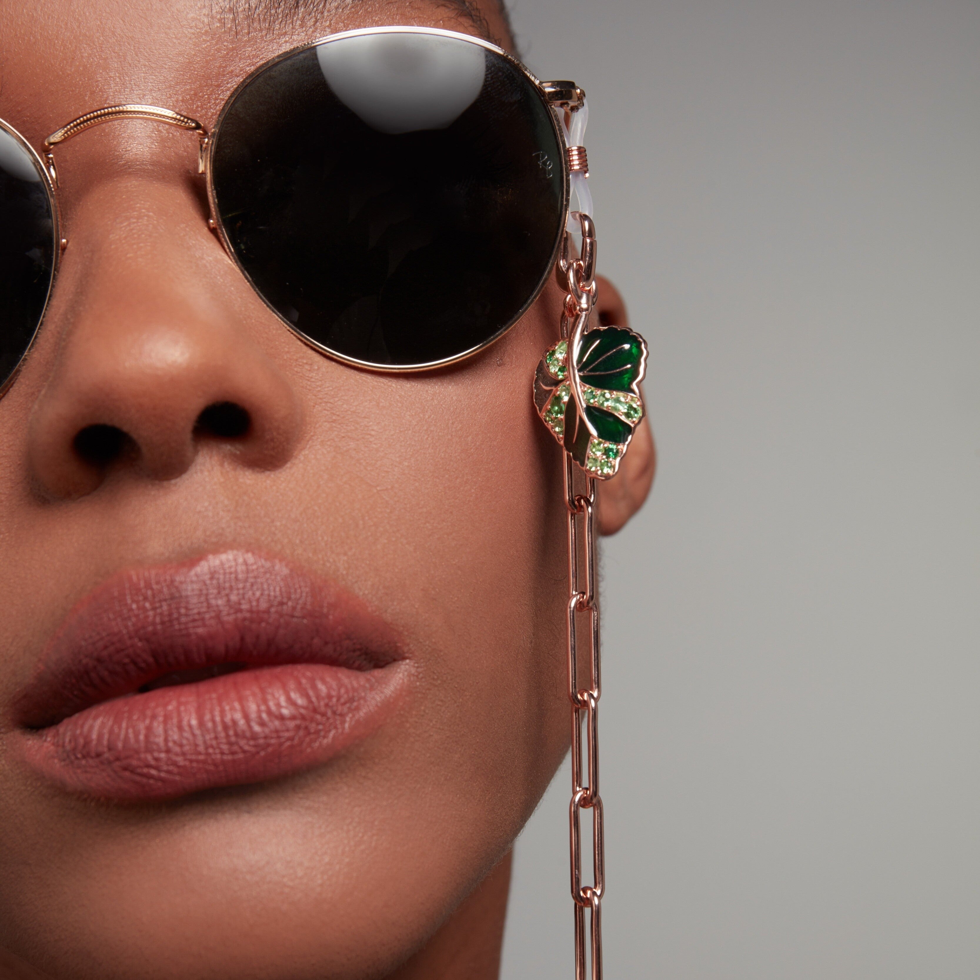 Rose gold sunglasses chain with green enamel monstera leaf charm accent