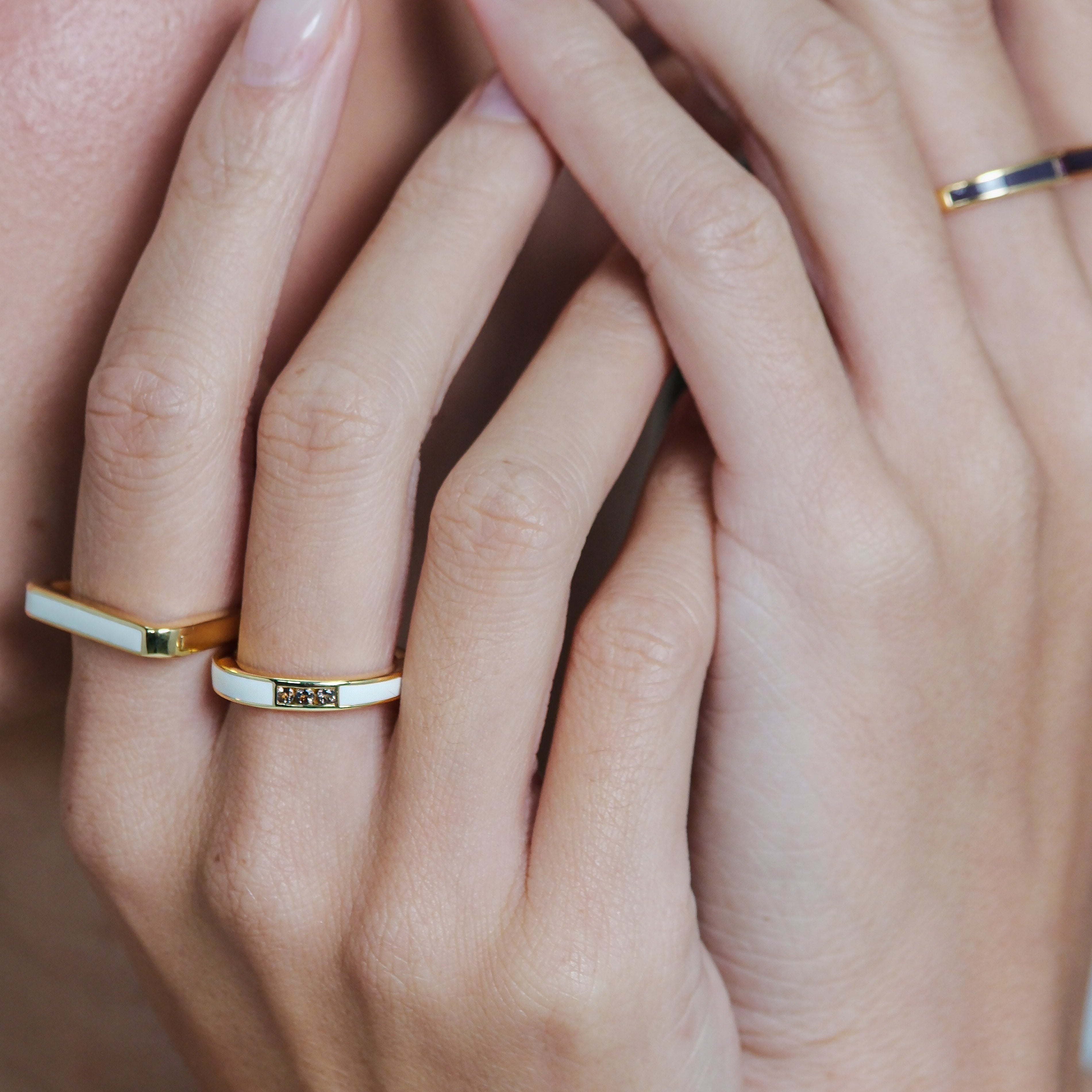 Close-up of hands with gold rings on fingers
