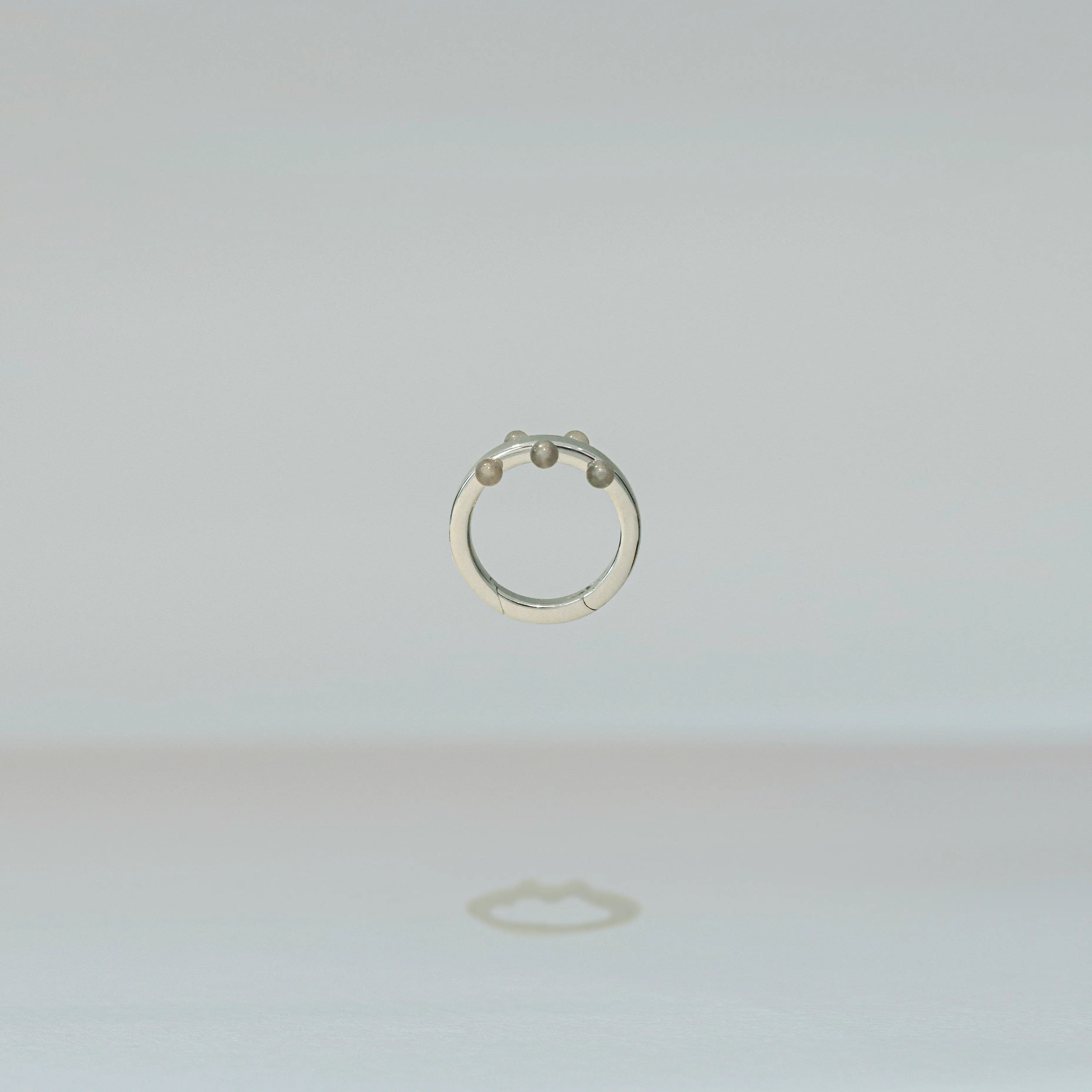 Silver ring on a light gray background